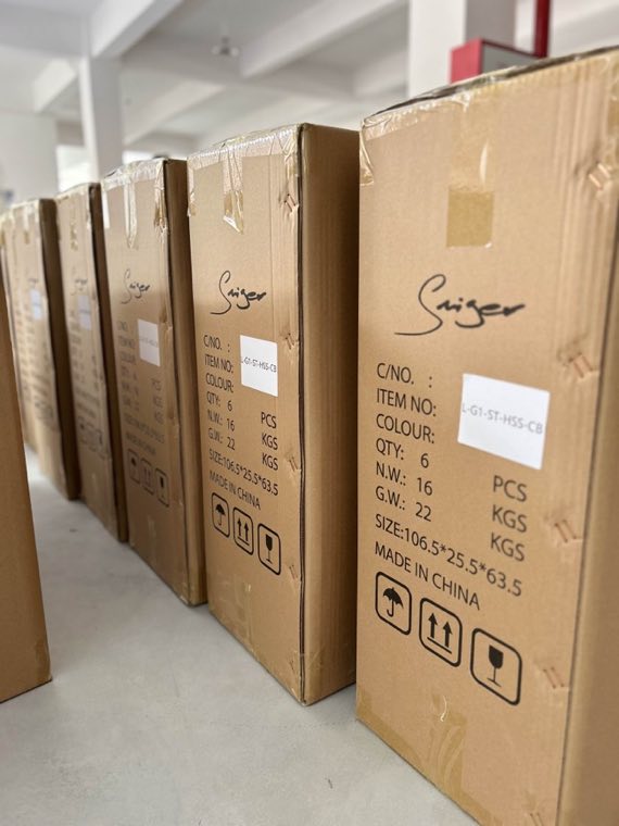 Labelled guitar cartons prepared in an organised warehouse area